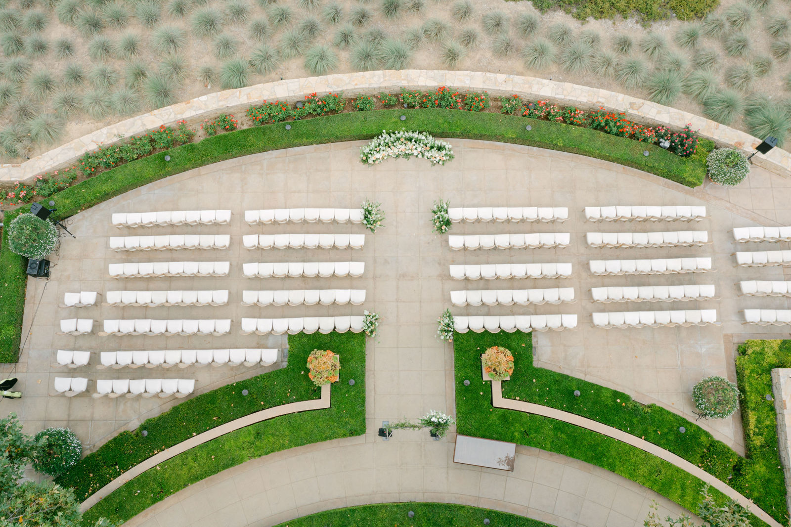 The ceremony from above at Shady Canyon, curved rows of white chairs in the hedge garden