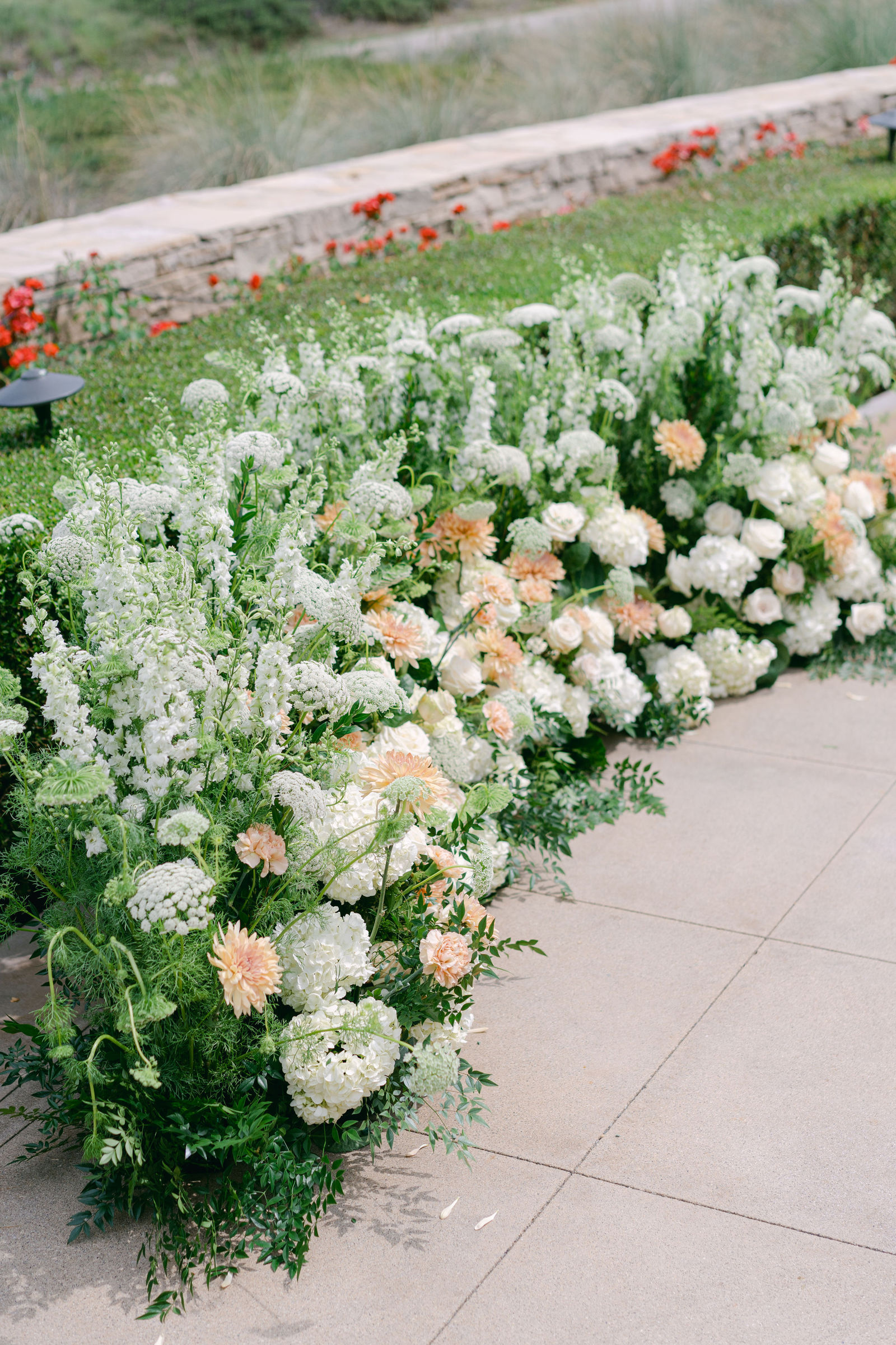 The ceremony set on the terrace at Shady Canyon Golf Club, white chairs in curved rows above the canyon