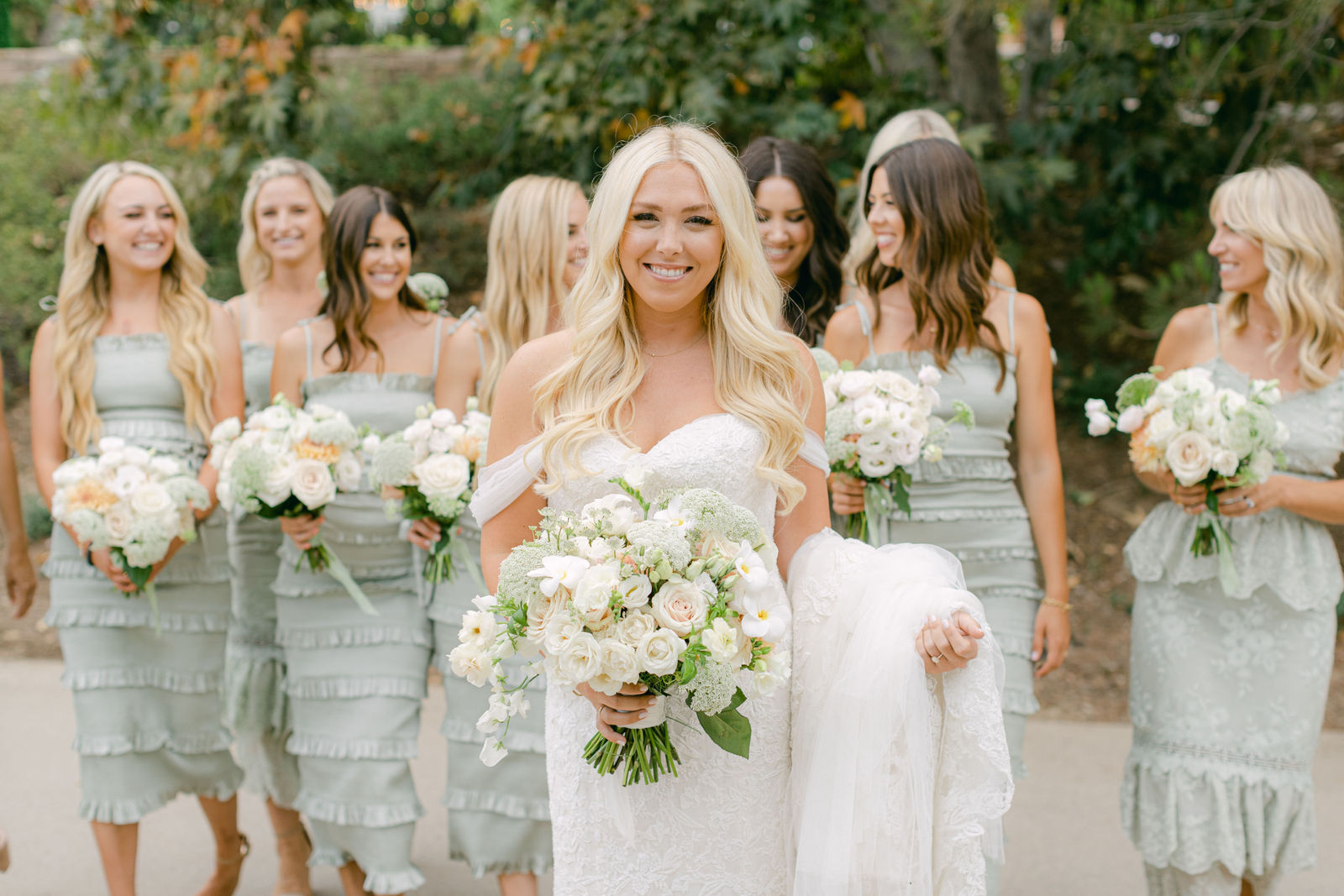 The bridal party in sage and black tie before the ceremony