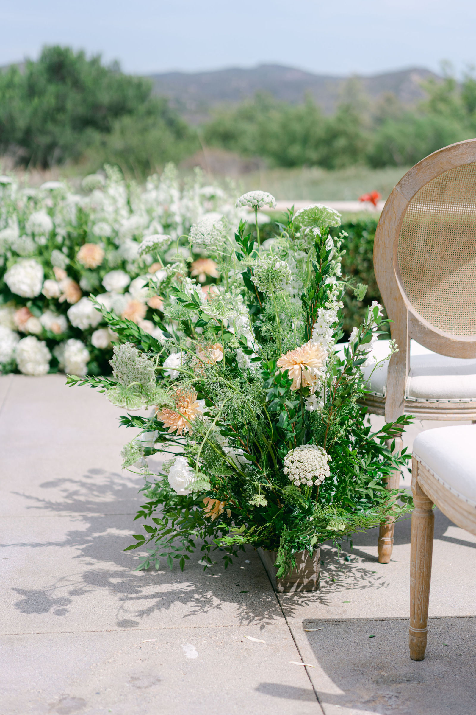 Bridesmaids in sage with white and peach bouquets