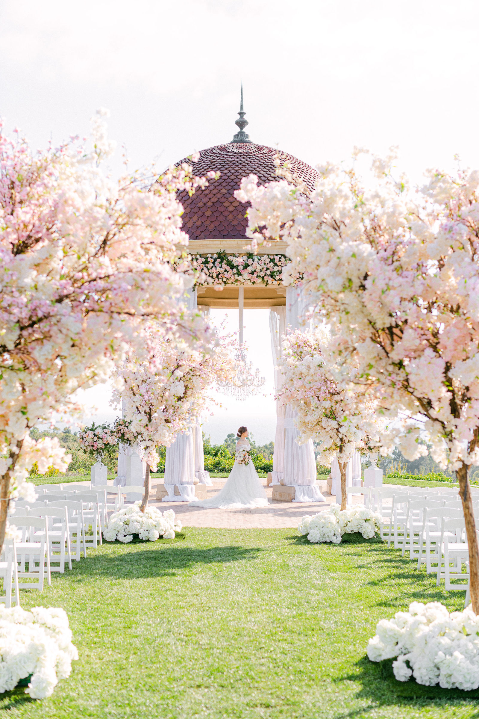 Cherry blossom trees lining the aisle to the rotunda at Pelican Hill