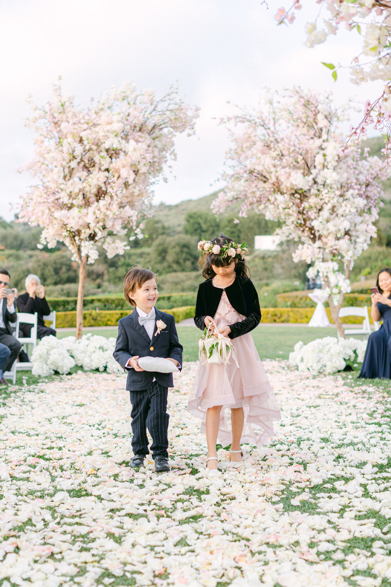 The flower girl and ring bearer on the petal aisle