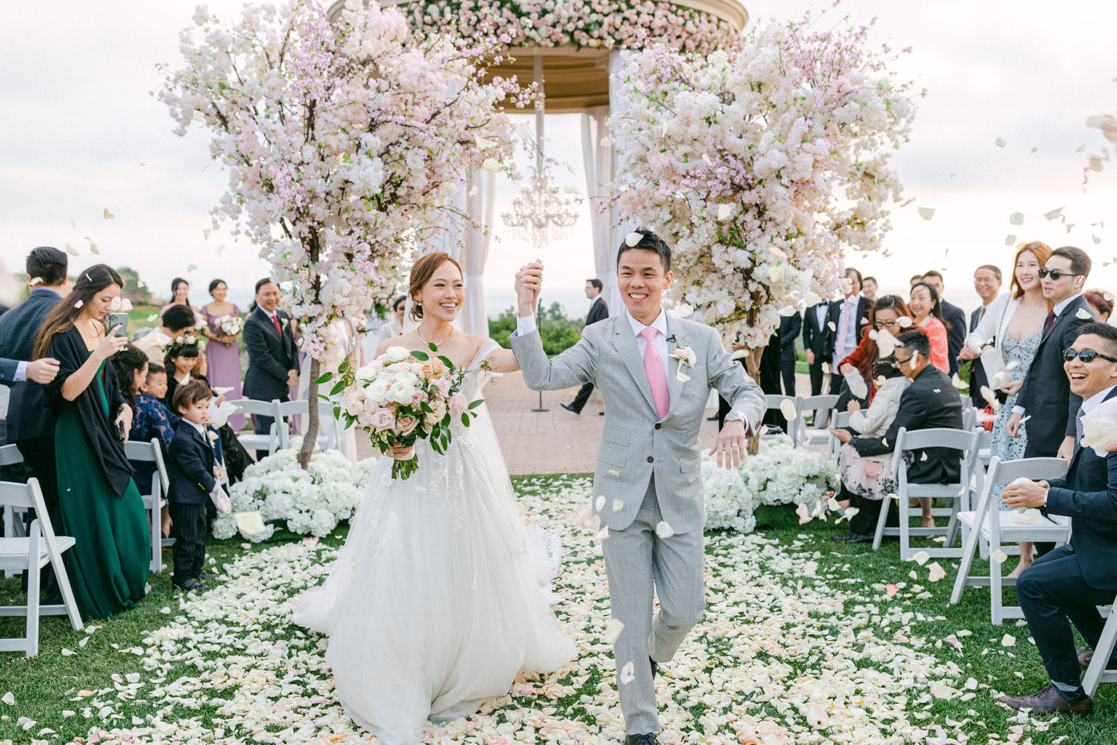 The recessional at Pelican Hill, arms up, guests on their feet