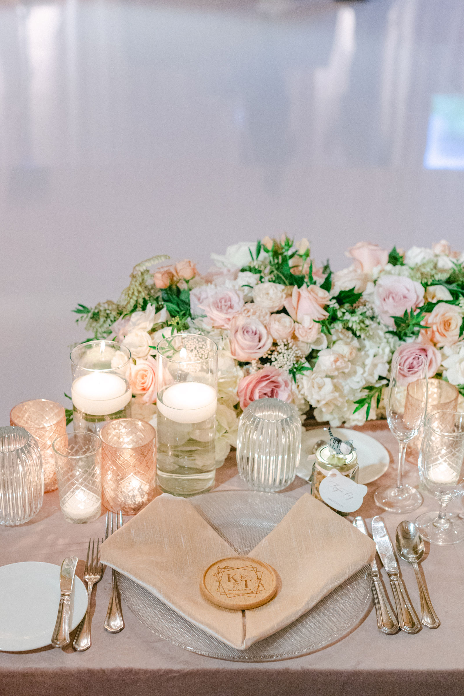 A gold place setting and candlelight at Pelican Hill