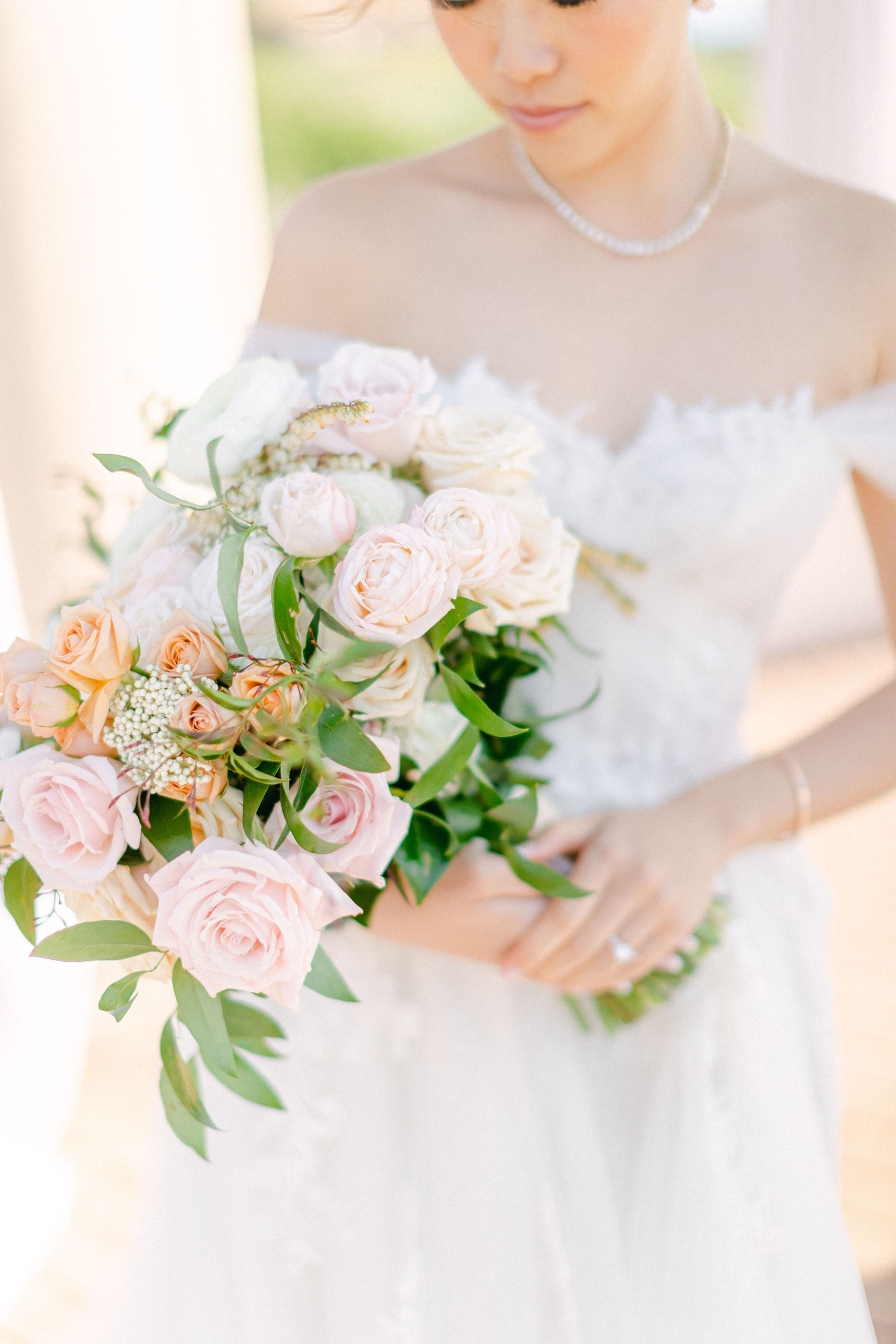 The bridal bouquet of blush and peach garden roses