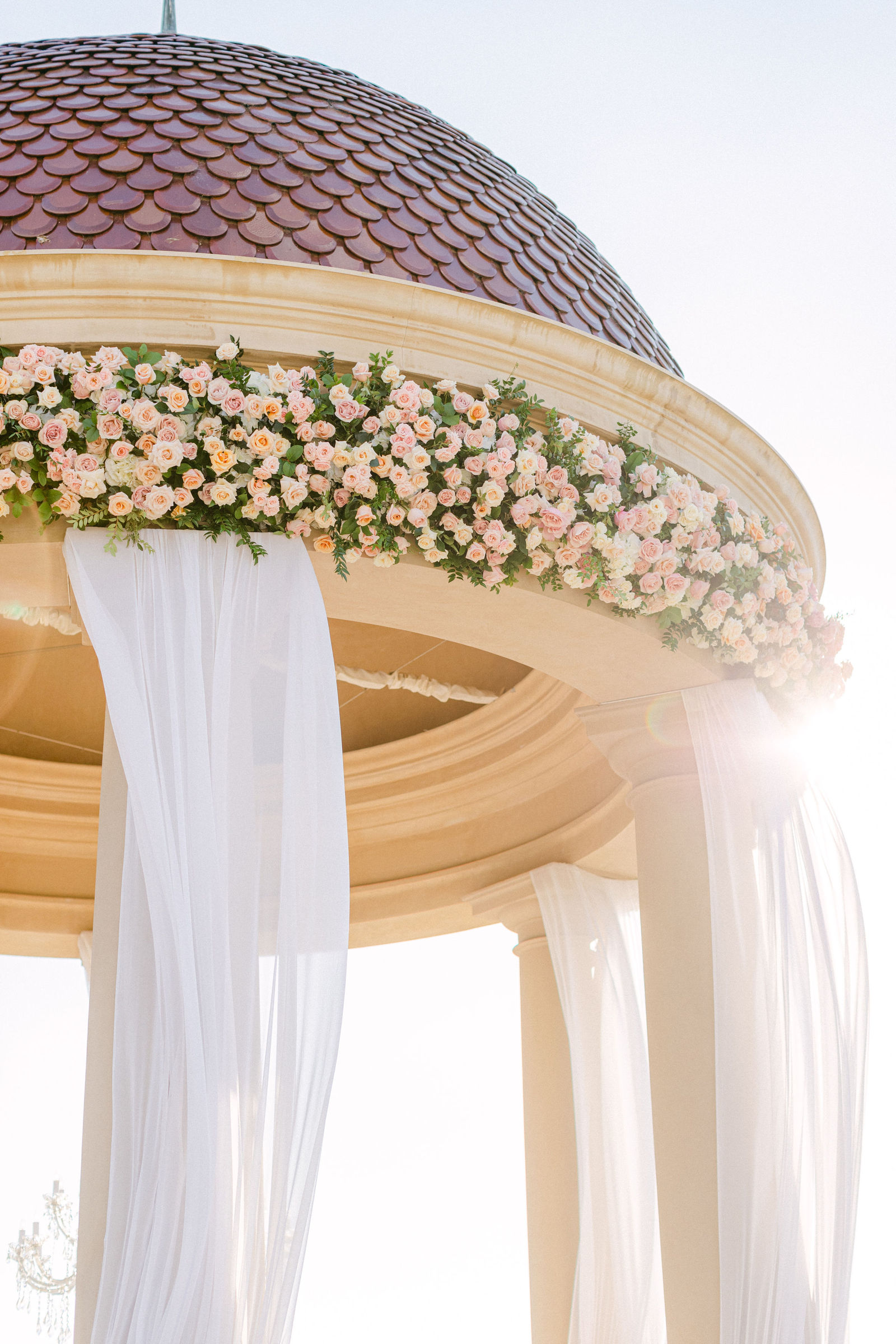 Blush roses banding the rotunda dome at Pelican Hill, white drapery beneath