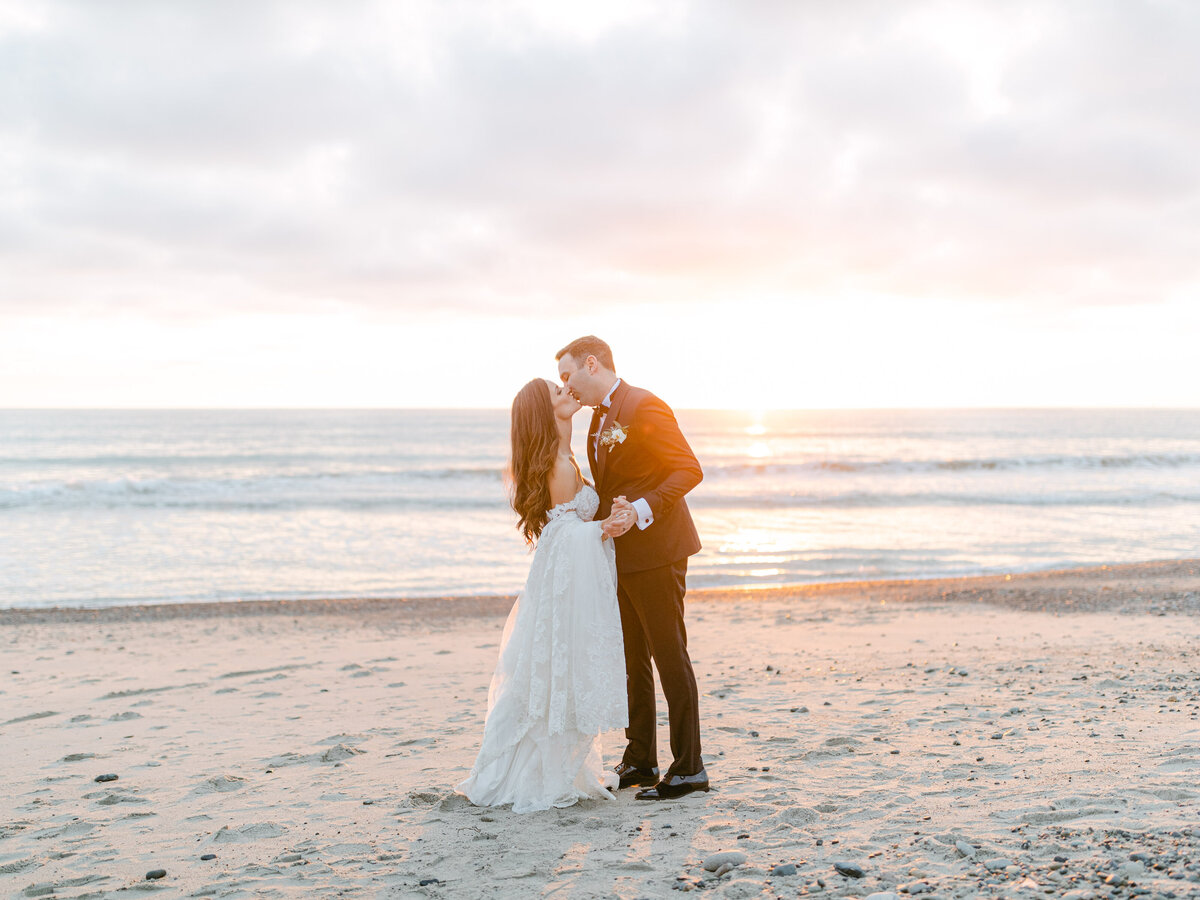 A kiss on the wet sand as the sun goes down
