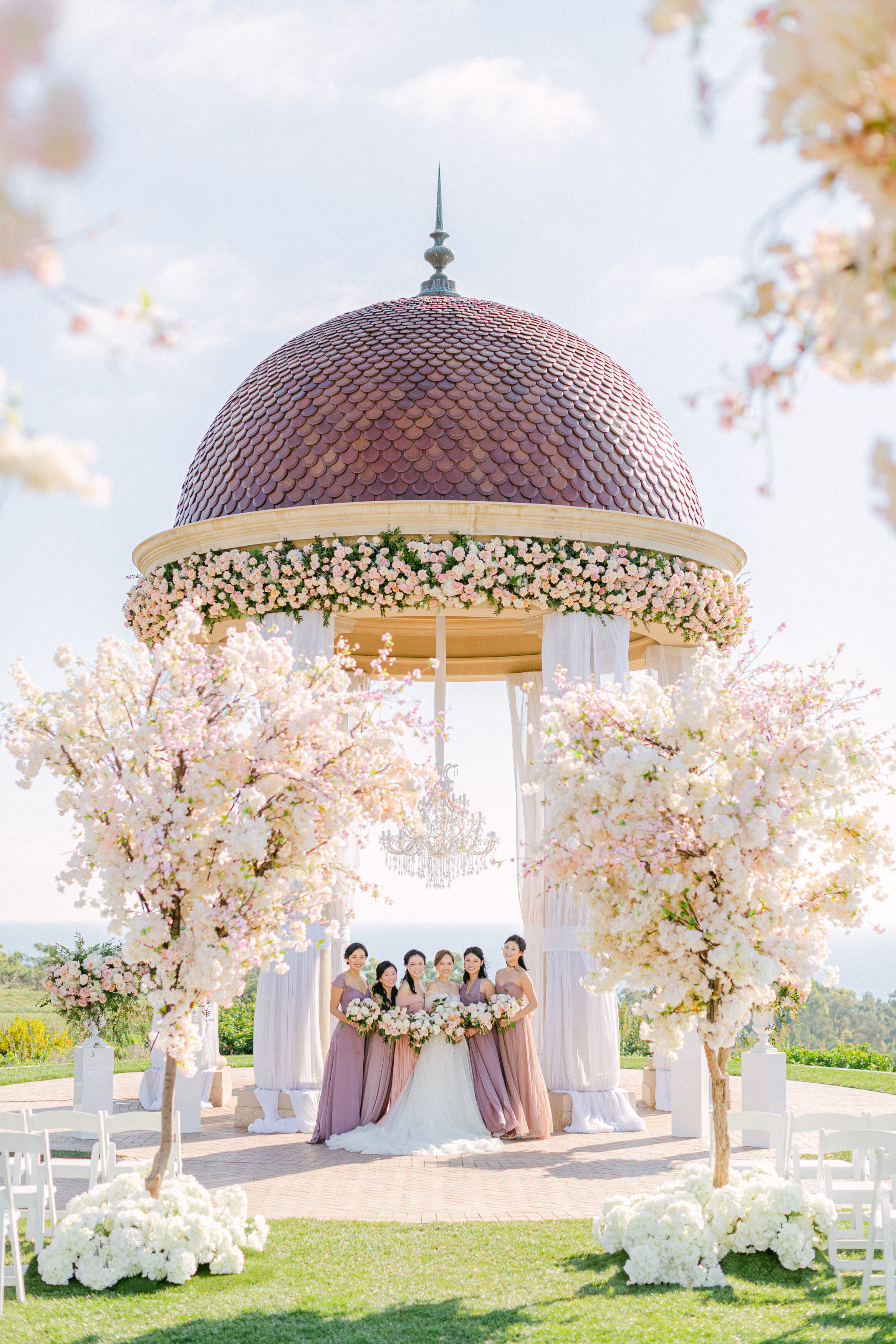 Wedding ceremony at the Pelican Hill rotunda wrapped in cherry blossoms